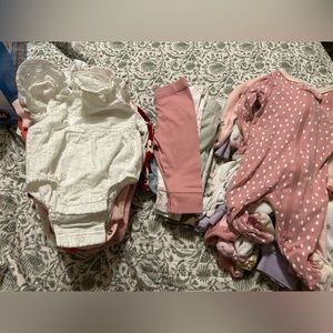 Newborn girl clothes pants sleepers and onesies.